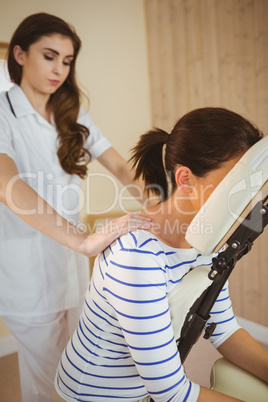 Young woman getting massage in chair