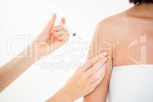 Woman receiving injection on arm