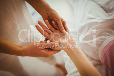 Young woman getting hand massage