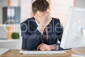 Worried businessman working at his desk