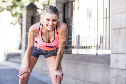 Pretty blonde woman preparing herself for a run