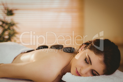 Young woman getting a hot stone massage