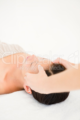 Attractive young woman receiving head massage