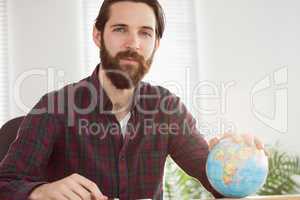 Hipster businessman with a globe