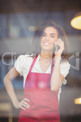 Smiling waitress talking on the phone