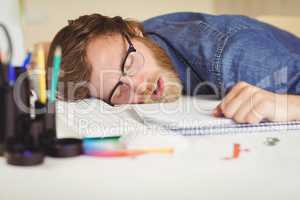 Hipster businessman sleeping at his desk