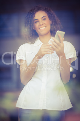 Smiling woman sending a text