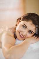 Young woman lying on massage table