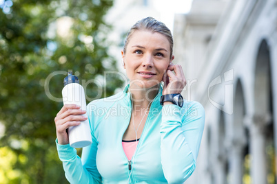 A beautiful woman holding a bottle of water