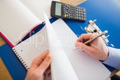 Businessman hands writing on a notebook