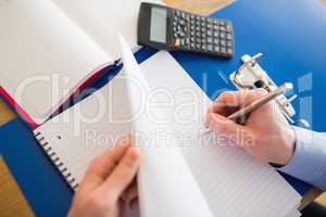 Businessman hands writing on a notebook