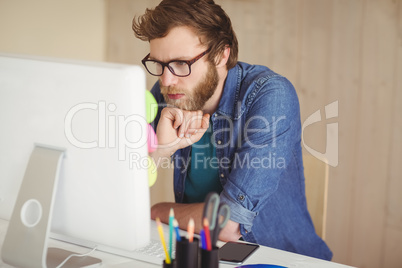 Focused hipster working at his desk