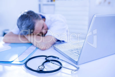 Female doctor sleeping on desk