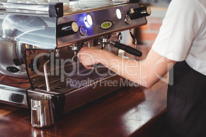 Barista preparing coffee machine