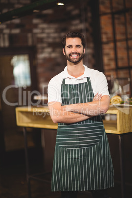 Smiling barista with arms crossed