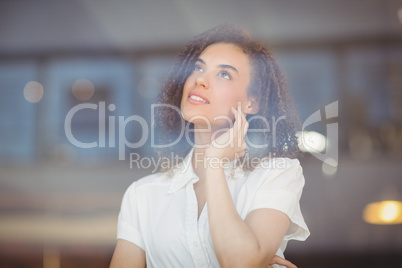 Thoughtful woman looking through windows