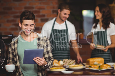 Smiling customer looking at tablet