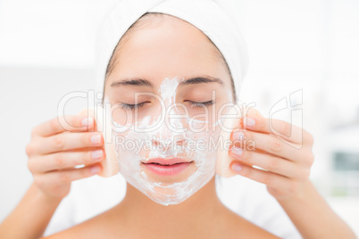 Hands cleaning woman face with sponge