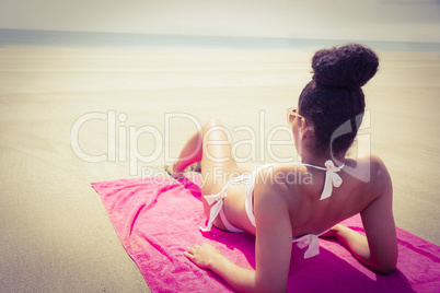 Slim woman sunbathing on towel