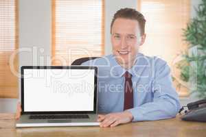 Happy businessman showing laptop screen
