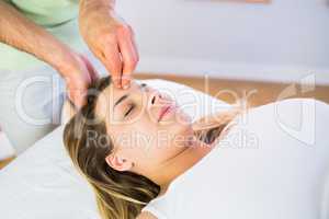Relaxed pregnant woman enjoying head massage