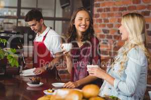 Female friends having coffee at coffee shop