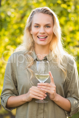 Young happy woman holding a glass of wine