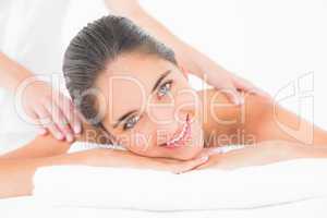 Attractive woman receiving shoulder massage at spa center