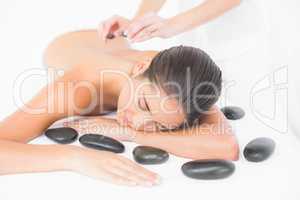 Pretty woman enjoying a hot stone massage