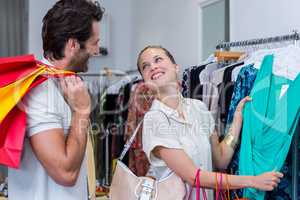 Smiling woman showing dress to boyfriend