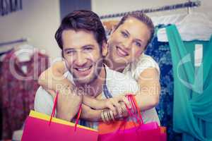 Smiling couple with shopping bags embracing