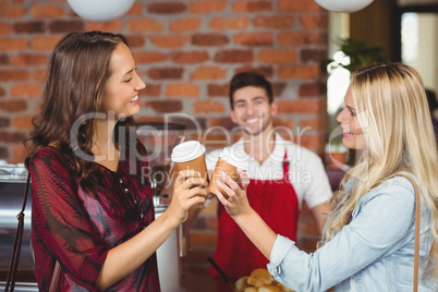 Two pretty customers toasting together