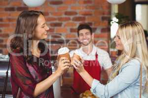 Two pretty customers toasting together