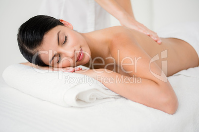 Pretty brunette enjoying a massage
