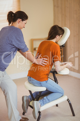 Young woman getting massage in chair