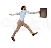 Handsome hipster leaping with briefcase