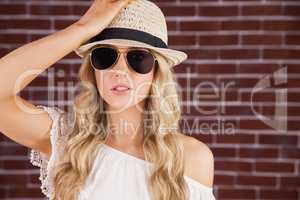 Gorgeous blonde hipster posing with straw hat