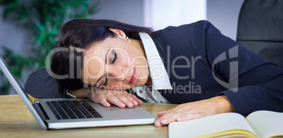 Businesswoman taking a nap on her desk