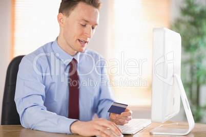 Businessman shopping online at desk