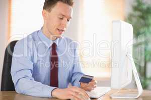 Businessman shopping online at desk