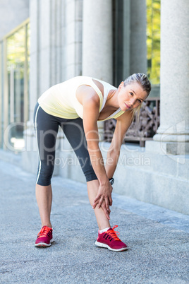 A beautiful woman stretching her leg