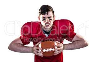 American football player crushing a ball