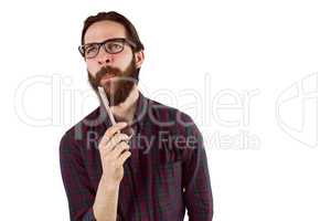 Handsome hipster thinking and holding pen