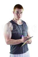 Fit personal trainer writing on clipboard