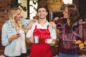 Smiling waiter and customers looking at the camera