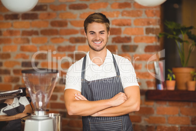 Handsome waiter with arms crossed