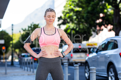 A beautiful athlete with her hands on her hips