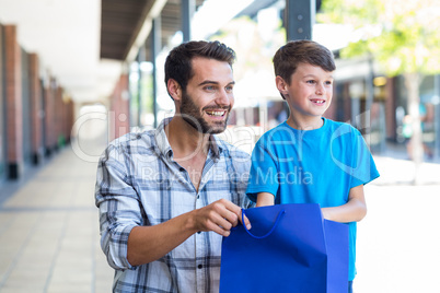 A father and his son looking away