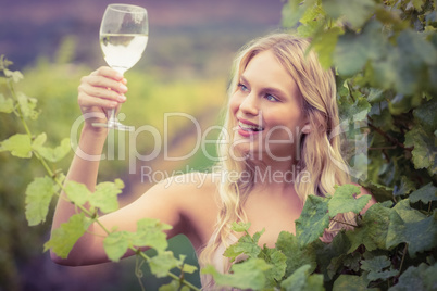 Young happy woman holding a glass of wine