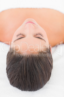 Beautiful pretty young woman on massage table